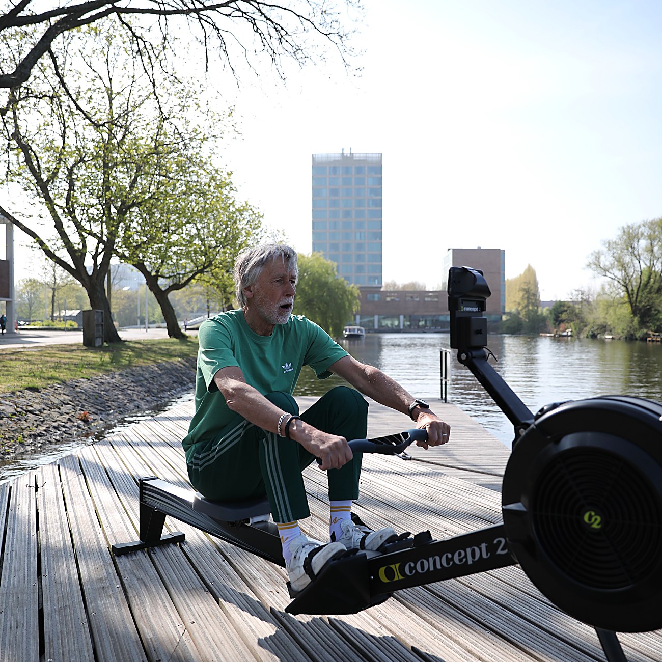 A MudaGym client rowing on the Concept2 by the water